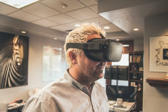 man standing and using virtual reality headset to enter the metaverse