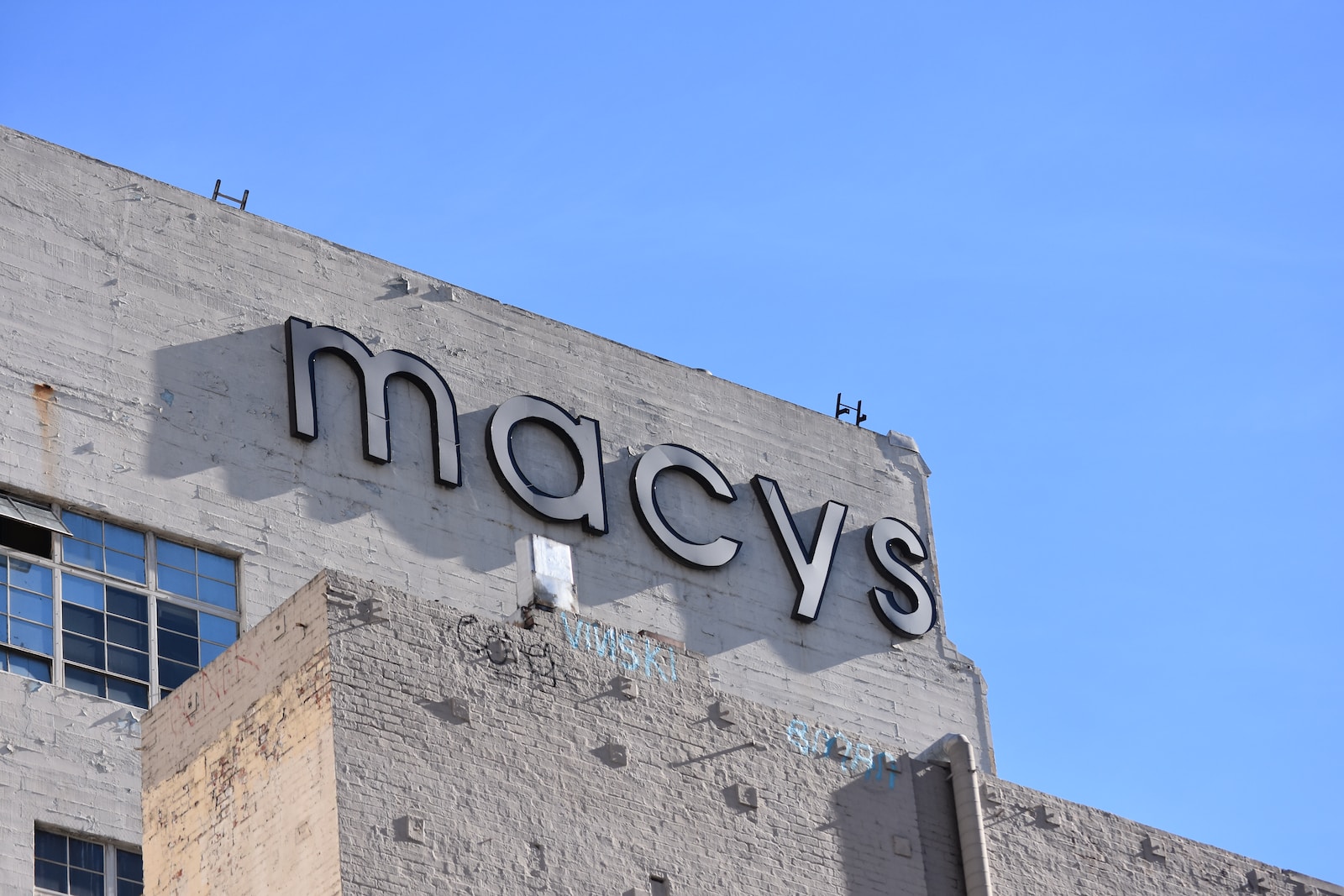 low angle photo of gray concrete building under blue sky during daytime